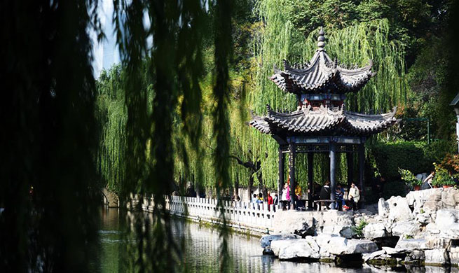 Tourists view scenery along moat in Jinan, China's Shandong